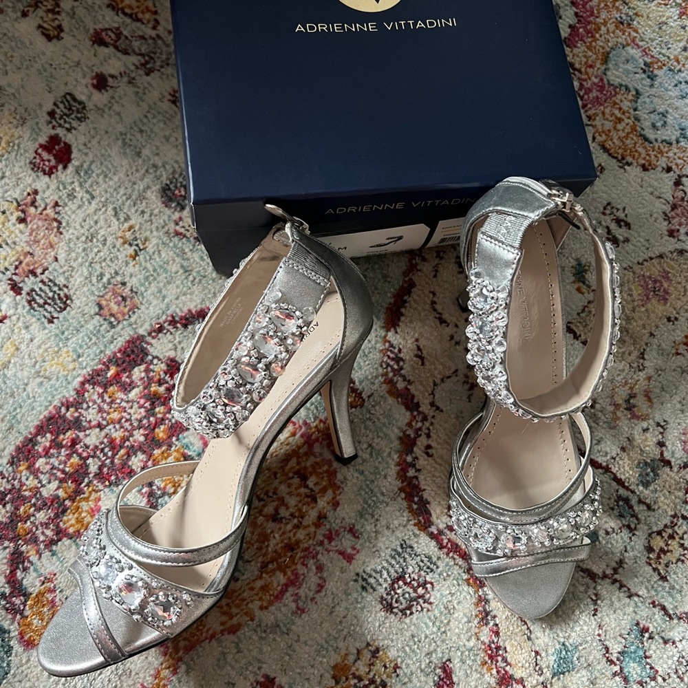 Silver evening shoe with rhinestone accents.